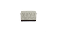 Small ottoman with a patterned cover on a white background