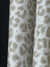 Close-up of a fabric with a leopard print pattern on a black background