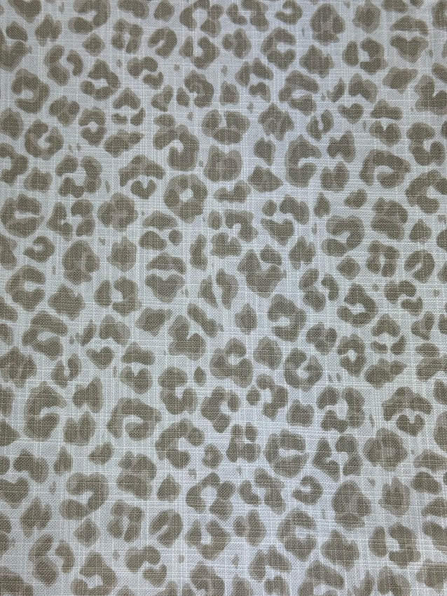 Leopard print pattern on a textured fabric background