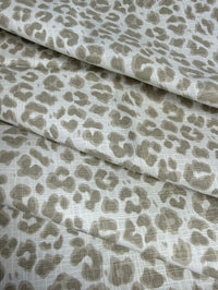 Leopard print fabric with beige spots on a white background