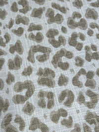 Leopard print pattern on a textured fabric background