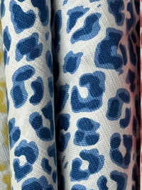 White fabric with blue leopard print pattern