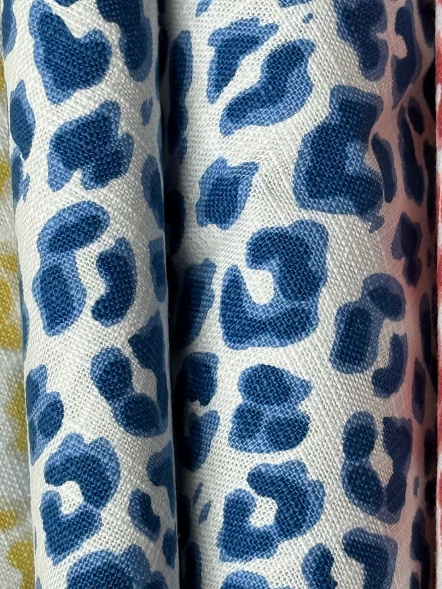 White fabric with blue leopard print pattern