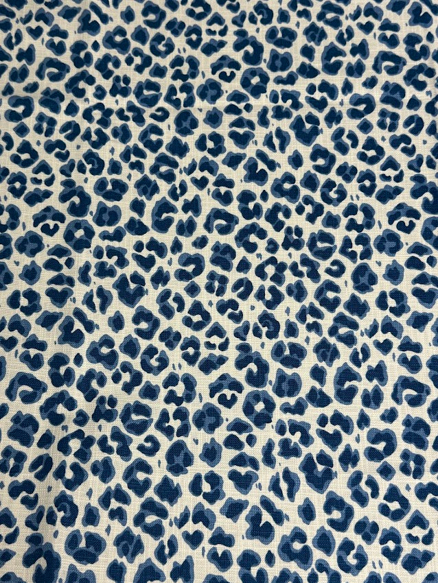 Blue leopard print pattern on a beige background