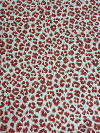 Red leopard print pattern on a light background