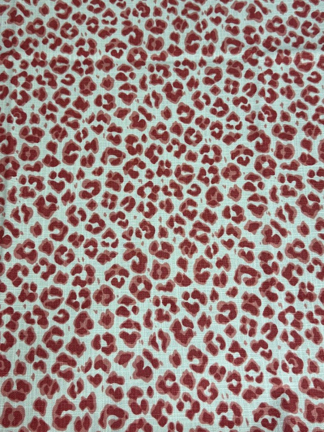 Red leopard print pattern on a light background