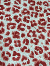 Red leopard print pattern on a textured white background