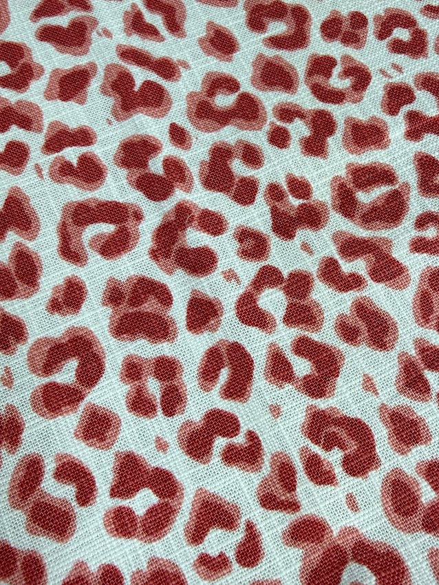 Red leopard print pattern on a textured white background