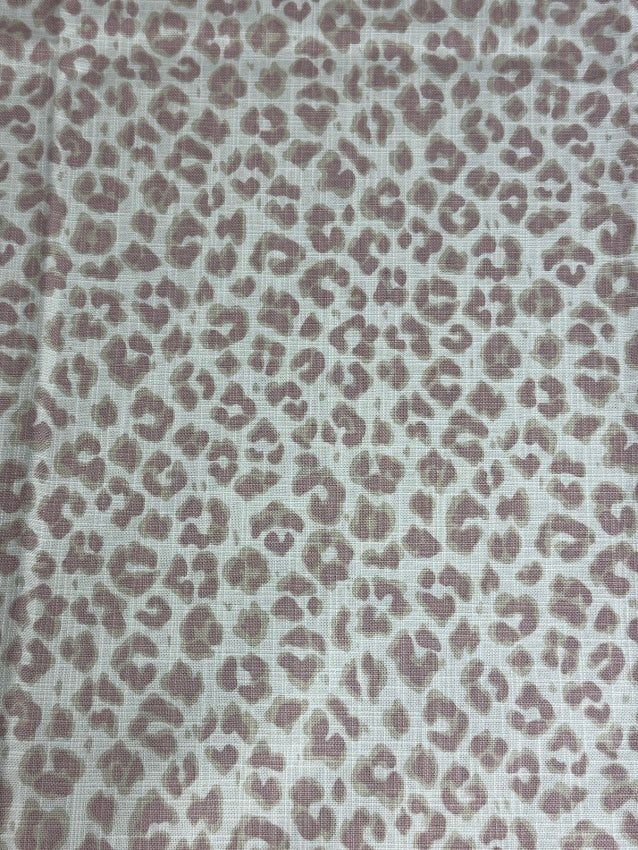 Leopard print pattern on a textured fabric background