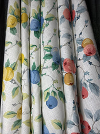 Set of fabric swatches with floral and fruit patterns on a neutral background