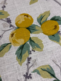 Close-up of a textured fabric with lemon and leaf pattern