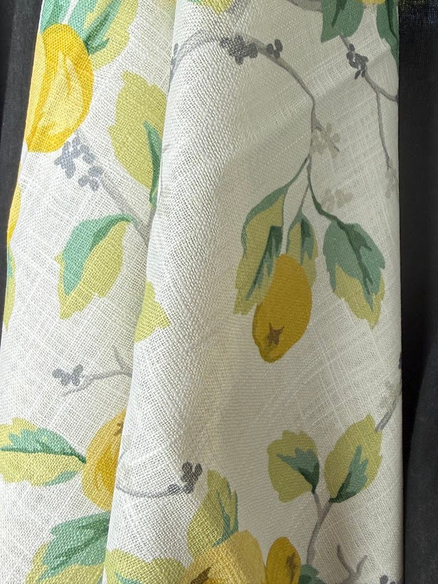 Fabric with lemon and leaf pattern on a white background