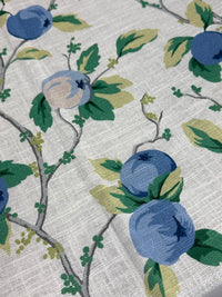 Close-up of fabric with blue fruit and green leaves pattern
