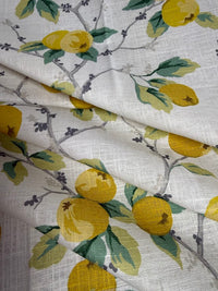 Fabric with lemon and branch pattern on a white background