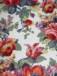 Floral patterned fabric with red, green, and blue flowers on a white background