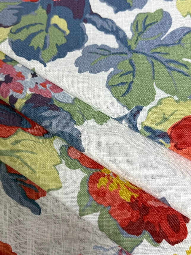 Close-up of colorful floral and leaf-patterned fabric swatches.
