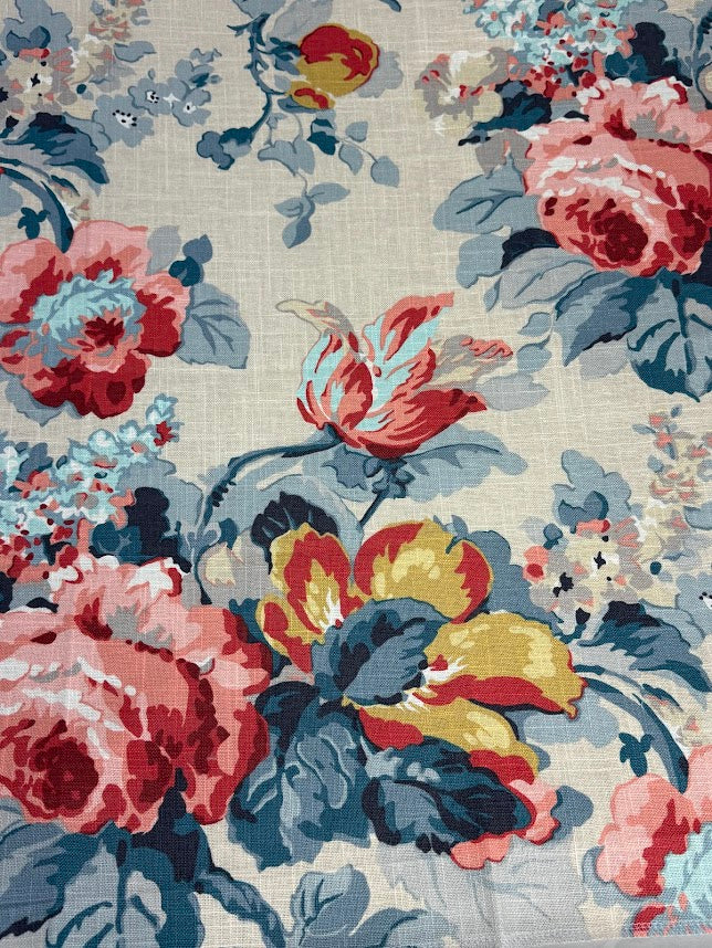 Floral patterned fabric with red, yellow, and blue flowers on a beige background