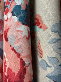 Floral patterned fabric with red, pink, and blue flowers on a white background