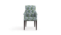 chair in fabric featuring a large scale geometric flame stitch pattern in green, aqua, and teal colors.