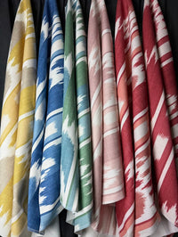 Set of colorful fabrics hanging side by side.