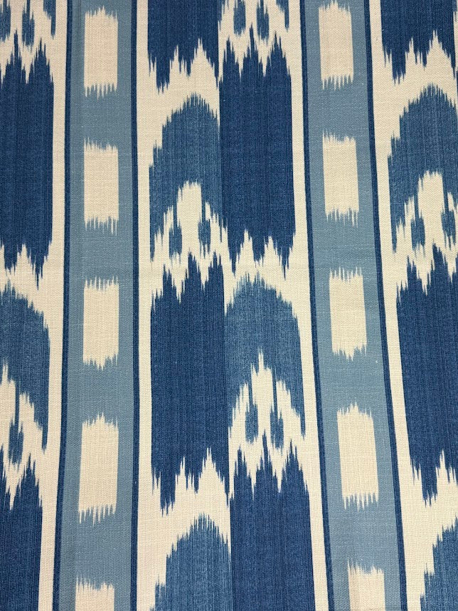 fabric featuring a French blue geometric pattern with vertical stripes and large scale flame stitch design.