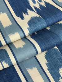 fabric featuring a French blue geometric pattern with vertical stripes and large scale flame stitch design.
