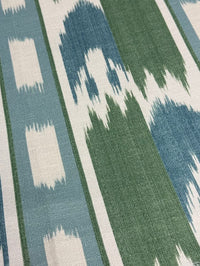 Close-up of a fabric with a geometric pattern in blue, green, and white.