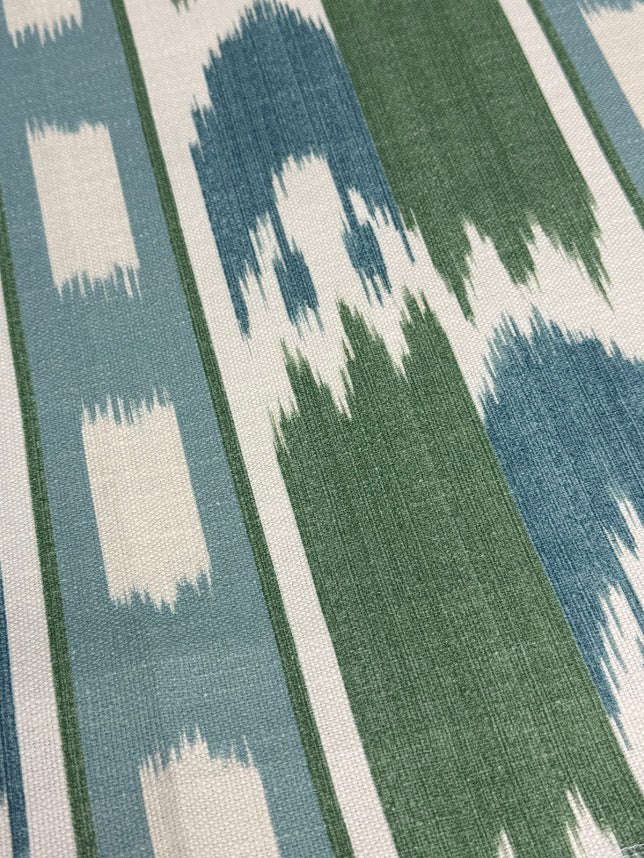 Close-up of a fabric with a geometric pattern in blue, green, and white.
