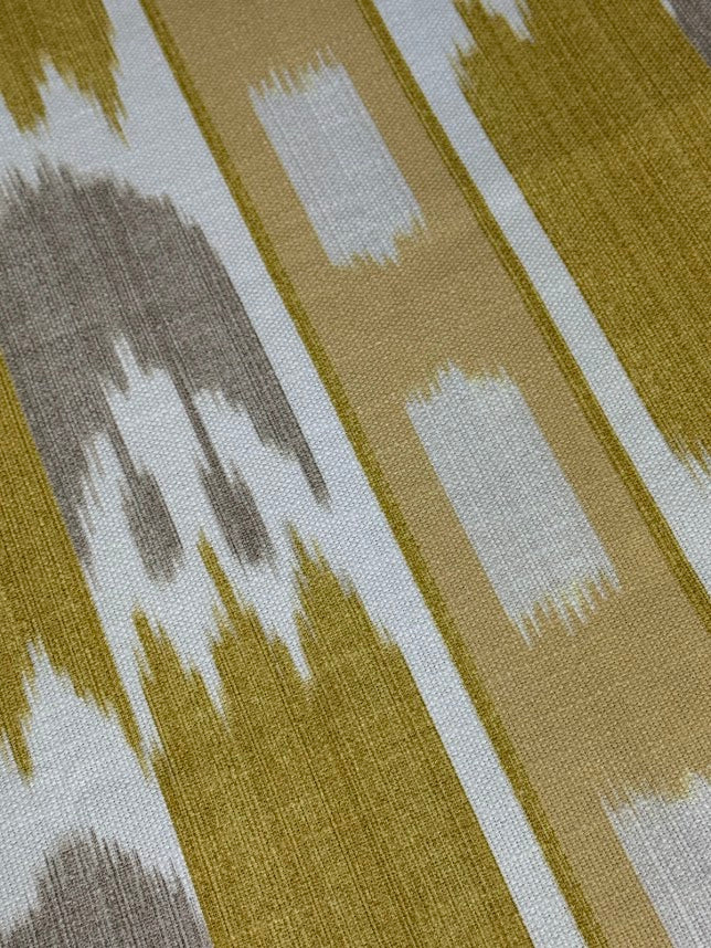close up of fabric featuring a yellow geometric pattern with flame stitch design