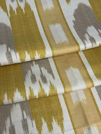 fabric featuring a yellow geometric pattern with flame stitch design