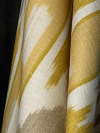 Close-up of fabric with yellow and white abstract pattern