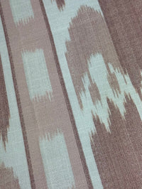 close up fabric featuring a vertical flame stitch pattern with geometric designs in pink and white colors 