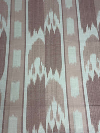 fabric featuring a vertical flame stitch pattern with geometric designs in pink and white colors 