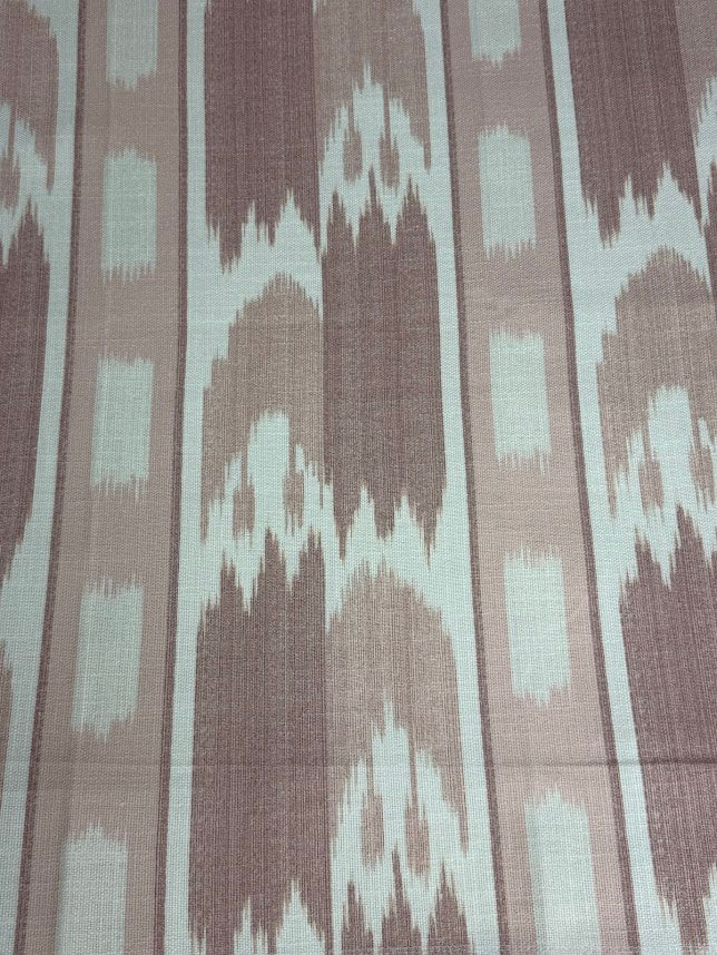 fabric featuring a vertical flame stitch pattern with geometric designs in pink and white colors 