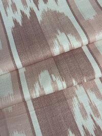 fabric featuring a vertical flame stitch pattern with geometric designs in pink and white colors 