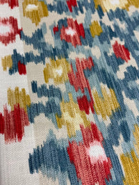 Close-up of a patterned fabric with red, blue, and yellow colors.