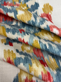 Close-up of patterned fabric with red, blue, and yellow colors.