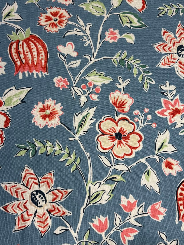 Floral pattern with red, pink, and green flowers on a blue background