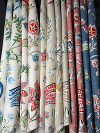 Collection of floral-patterned fabrics in various colors.