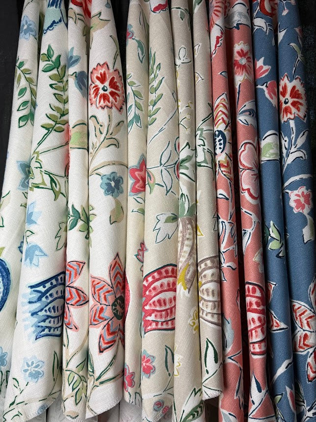 Collection of floral-patterned fabrics in various colors.