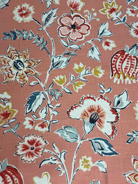 Floral patterned fabric with red, white, and beige flowers on a pink background