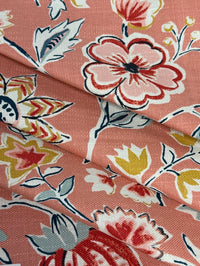 Floral fabric pattern with pink and red flowers on a coral background