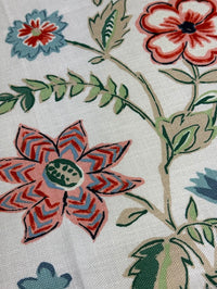 Close-up of floral pattern with red, blue, and green colors on a light background