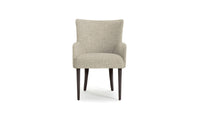 Beige upholstered maya dining chair with dark wood legs on a white background