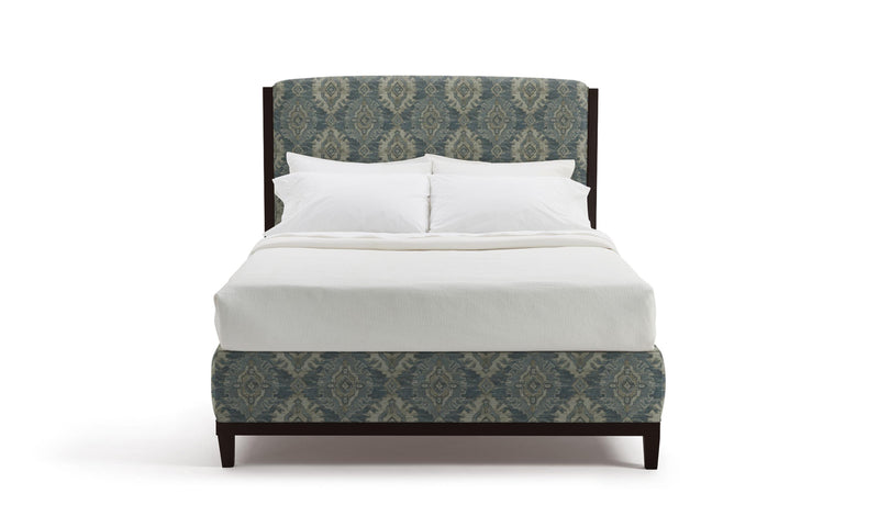Maddy Bed with patterned headboard and white bedding on a white background
