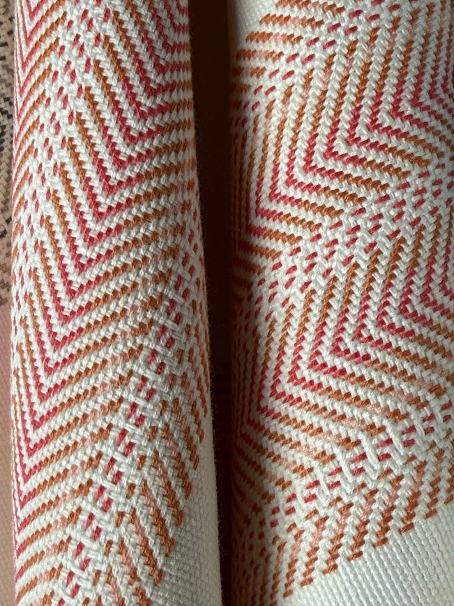 Close-up of a fabric with a zigzag pattern in red and white.