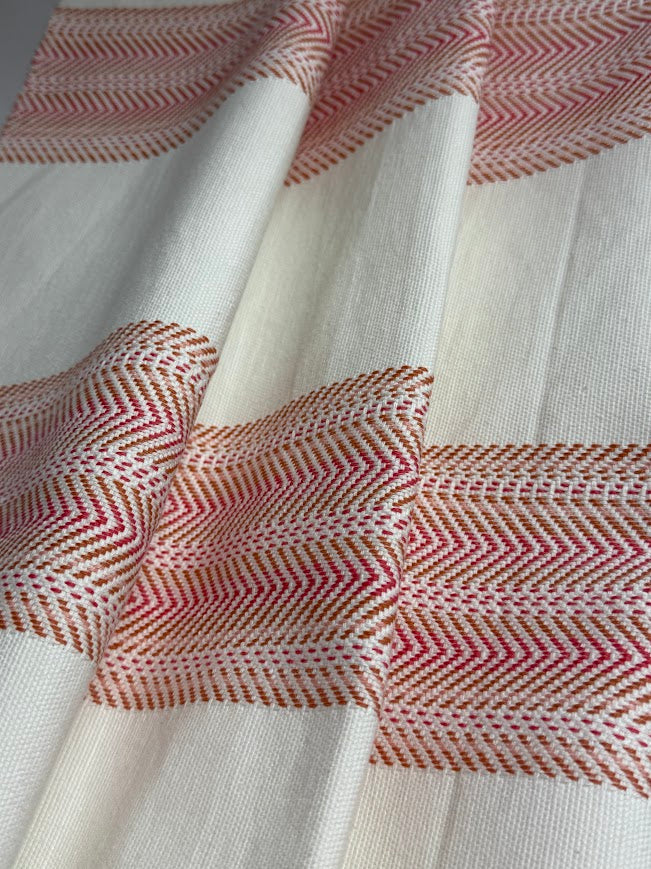 Close-up of fabric with red and white herringbone pattern 