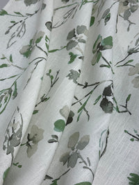 Floral patterned fabric with green and grey flowers on a white background